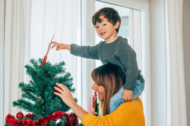 istock Mother and son putting star on Christmas tree 1188478836