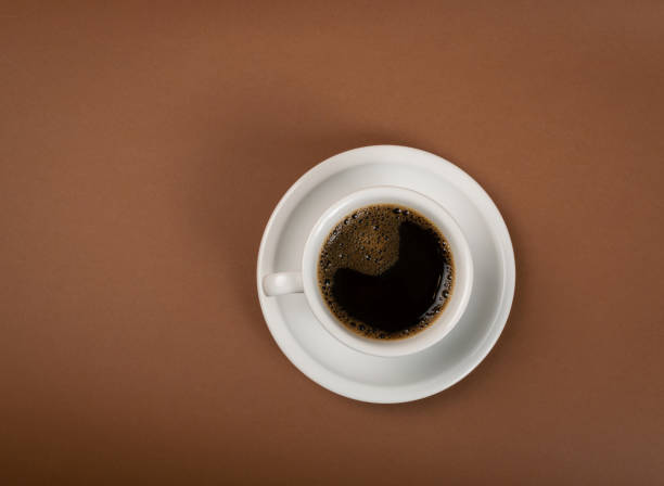 istock Hot coffee cup on brown background top view 1188478931