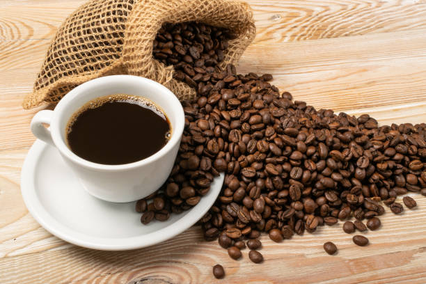 istock Hot coffee cup and coffee beans in burlap bag 1188478996