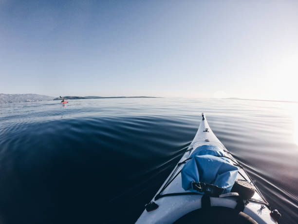 istock Two people kayaking over calm sea 1188479378