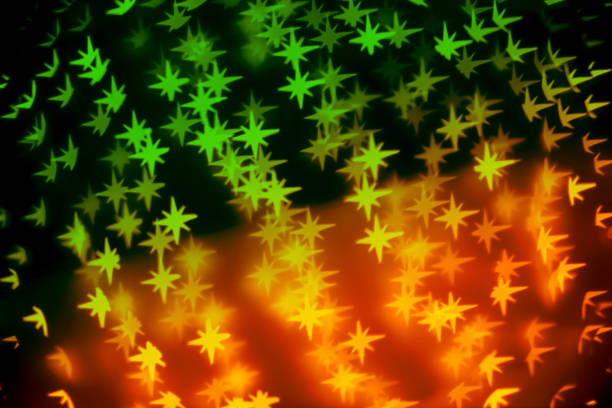 Multi colored Christmas background - defocused bokeh with a star shape. Space for copy. It's a REAL bokeh photo, not an illustration or computer filter.