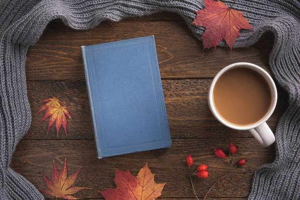 istock Autumn theme background with decorating elements, book and maple leaves on dark wood table. Creative Flat layout and top view composition 1188480795