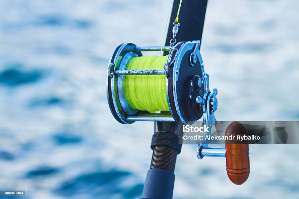 Trolling Fishing Boat Rod And Golden Saltwater Reel Deep Blue