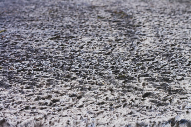 istock Texture of an old concrete wall with dimples, hollows with outgoing perspective. 1188481206