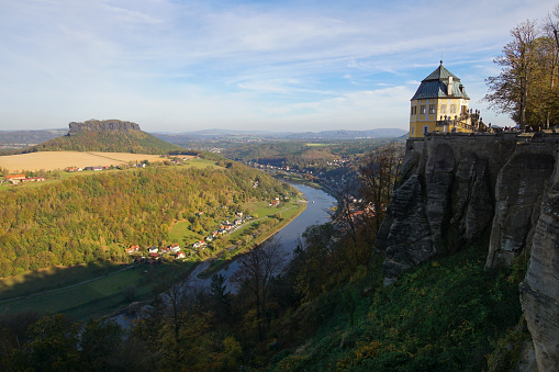 Königstein, Saxony, Germany - October 26 2019: A wall of the fortress Königstein in Saxony. It is one of the largest fortifications in Europe and is on top of a hill in the Saxon Switzerland. In the back is the Lilienstein