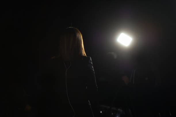 istock Journalist making a live broadcast in front of a spotlight 1188487134