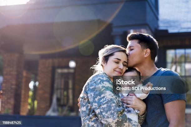 Mid Adult Man Kisses His Soldier Wife Stock Photo - Download Image Now - Family, Military, Veteran