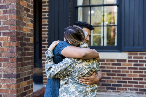 istock Husband hugs his soldier wife as she leaves for assignment 1188487444