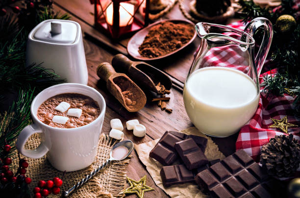 Christmas table setup with homemade chocolate mug, marshmallows on rustic table