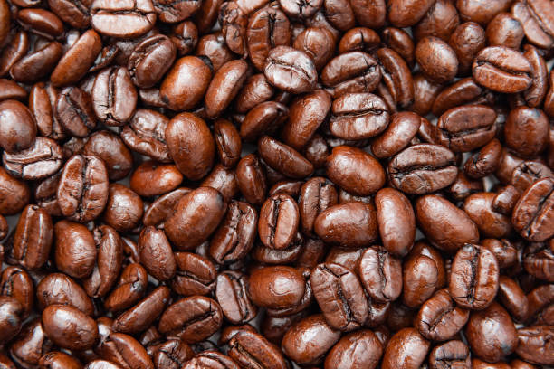 istock Close up whole roasted coffee beans background texture, flat lay. 1188496876