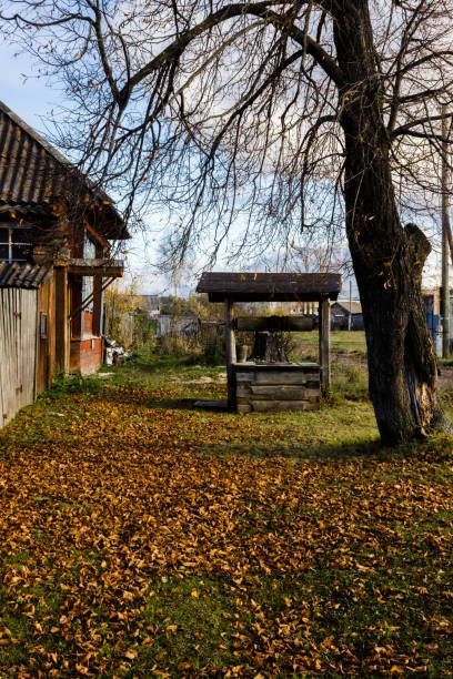 istock Village house with a well. Autumn 1188496996