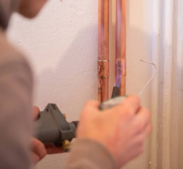 istock Plumber fixing jointing copper pipework with torch and solder in a residential home. 1188497114