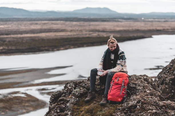 istock A woman sitting next to a red backpack 1188498879
