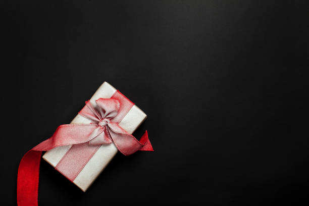 istock gift box on a black background, blank for postcard, poster, banner 1188502044