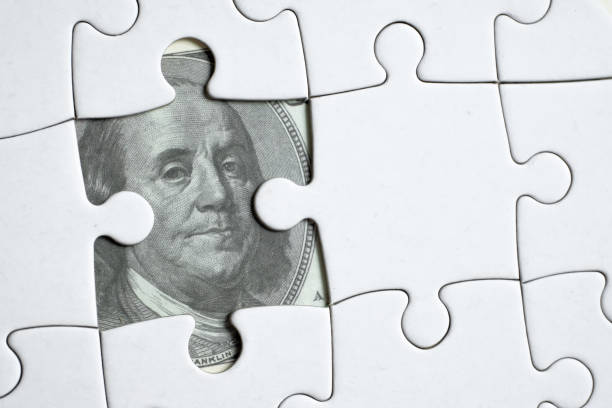 istock Image of one hundred dollar bills usa from a white puzzle. 1188502093