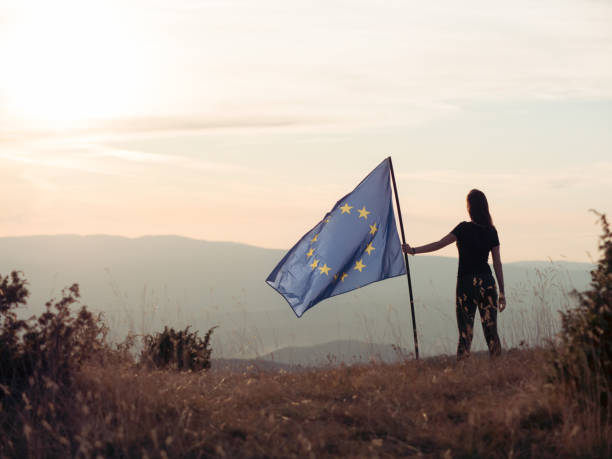 Woman holding European Union flag Woman holding European Union flag european union symbol stock pictures, royalty-free photos & images