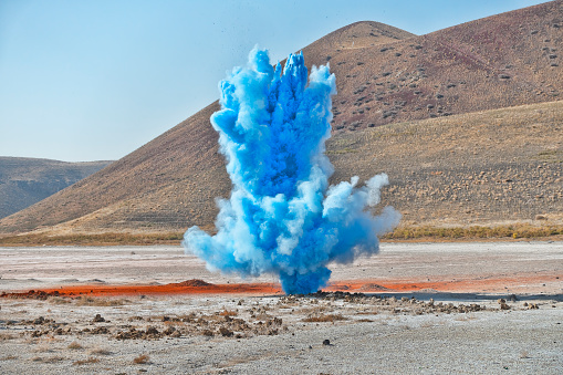 Colorful blue smoke bombs action in showing outside
