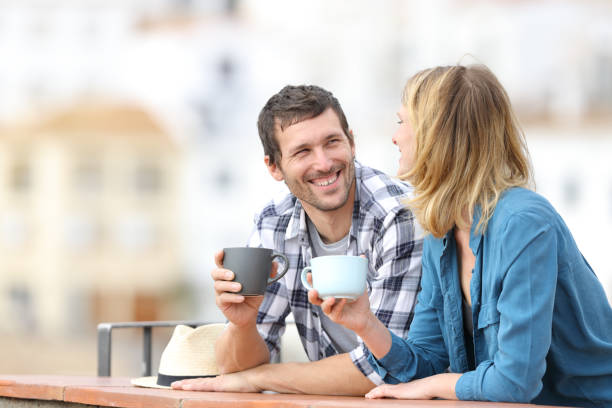 istock Happy couple talking holding mugs in a balcony 1188506214