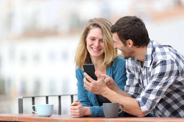 istock Happy adult couple talking about phone content 1188506233