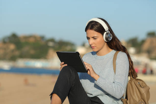 istock Serious girl e-learning with a tablet and headphones 1188506934