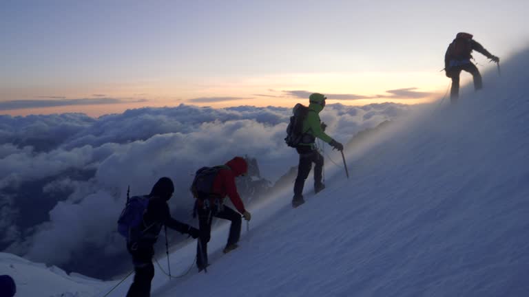 Men are climbing to the top of the mountain