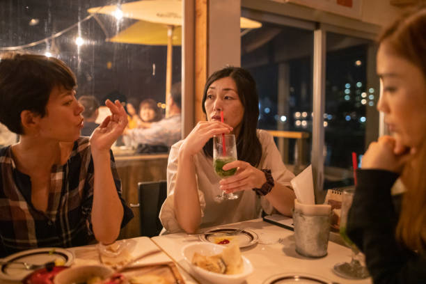 istock Female friends talking in cafe at night 1188509449