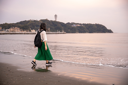 Woman walking closer to the sea