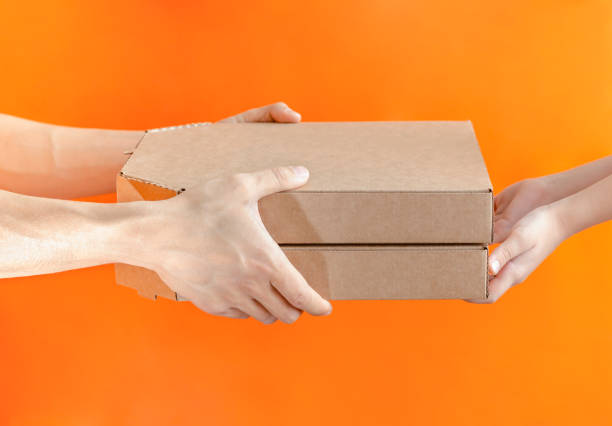 istock Delivery man giving two boxes with pizza to boy. Delivery concept. 1188510143