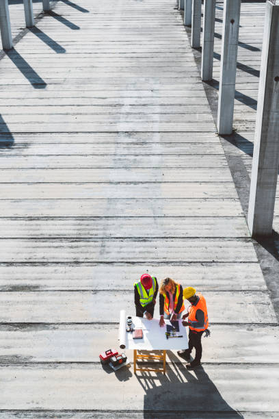 istock Aerial photo of three architects looking at blueprints with blank space 1188510419