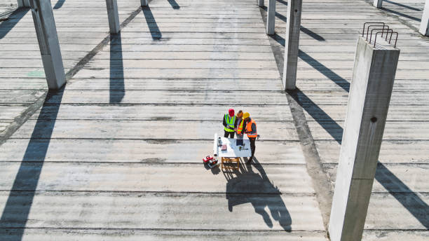 istock View from a far of three people working on construction site 1188510421