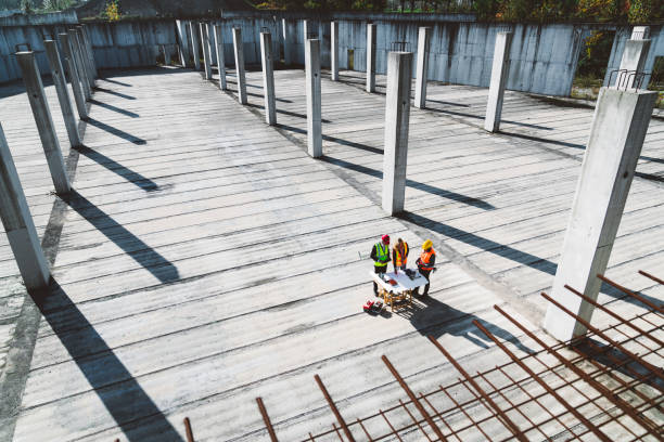 istock Aerial view of a large construction site and a small group of construction workers 1188510427