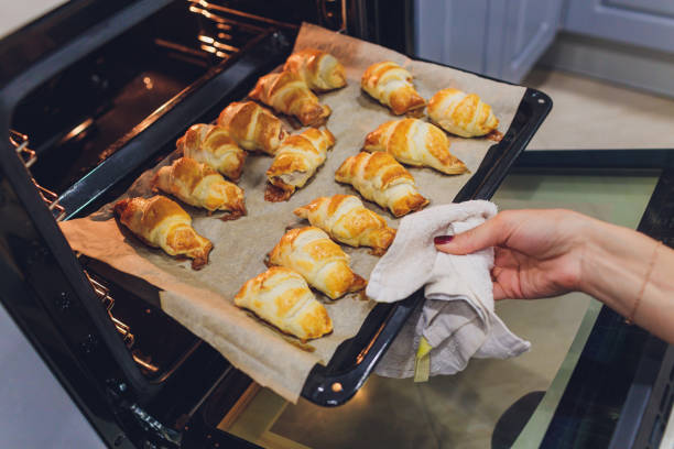 istock freshly baked croissants in the baking oven. 1188510486