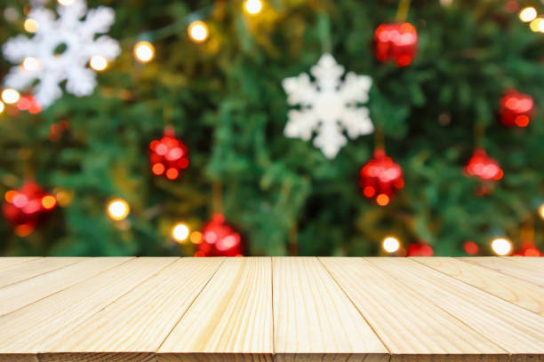 istock Empty wood table top with Abstract blur Christmas tree with decoration bokeh light background for product display 1188510732