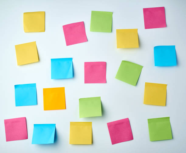 istock lot of blank square paper multicolored stickers on a white wall 1188511533
