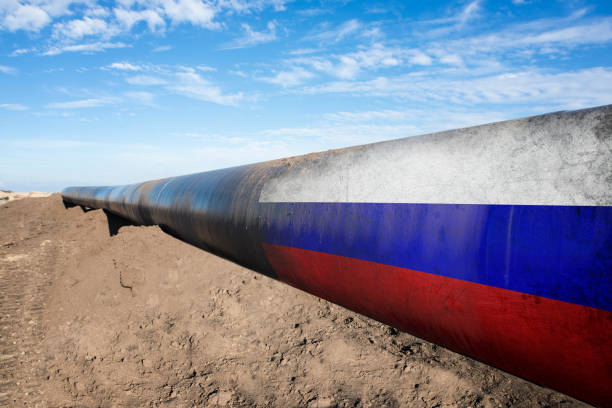 Gas pipeline with Russian flag. Concept of natural gas distribution through pipes with Russian flag on it. natural gas stock pictures, royalty-free photos & images