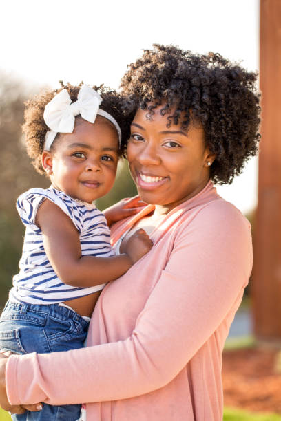 istock African American mother picking up her daughter. 1188514530