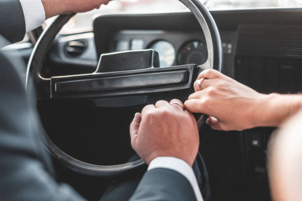 istock Couple in their car holding hands 1188516299