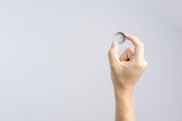 istock Hand holding classic beer or soda bottle cap 1188516332