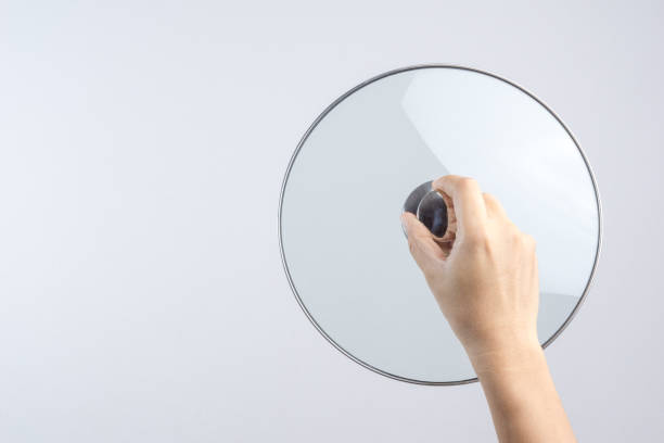 istock Hand holding glass lid for pan or pot 1188516364
