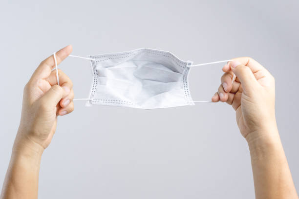 istock Hand holding black medical protective mask 1188516415