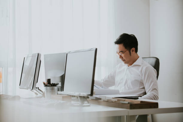 istock Thai manager men reading document in the office with positive emotion 1188516604