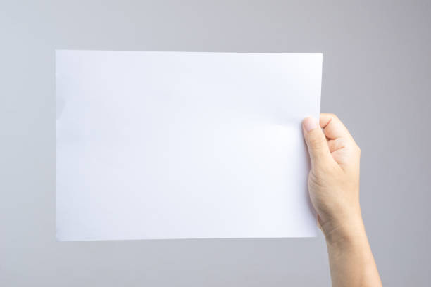 istock Hand holding blank paper easy replace with poster or brochure 1188516644