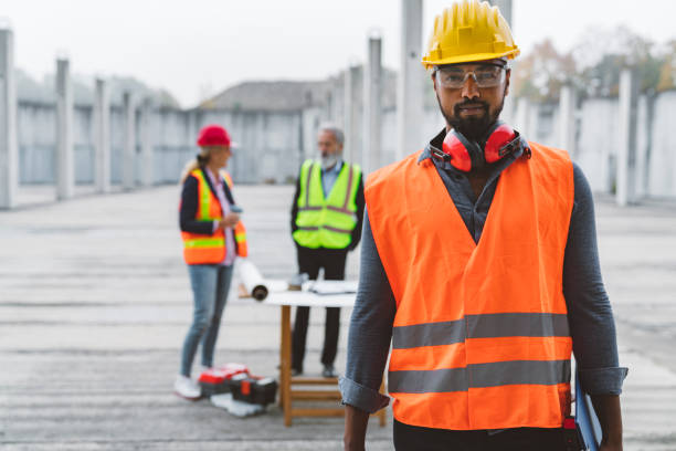 istock African American engineer and his colleagues in the background, working on construction site 1188517610
