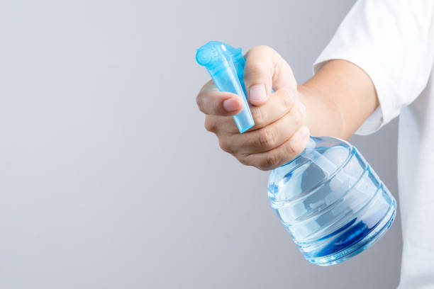 istock Hand holding blue plastic spray bottle contain pure water 1188517694
