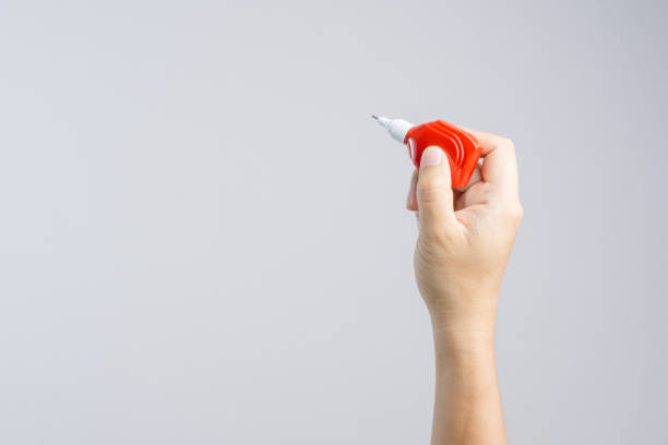 istock Hand holding correction pen or liquid paper for correct hand writing mistakes 1188518308