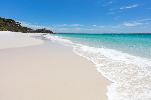 White sand and blue sky, tranquil beach scene from Jervis Bay, New South Wales, Australia.