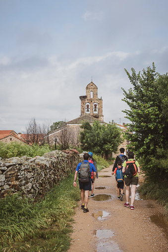 A Spanish family walking the Camino de Santiago enters the village of Santa Catalina de Somoza in Spain's Castile and León region. (June 30, 2018)