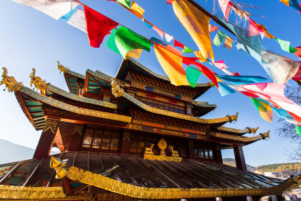 Guishan temple with giant buddhist tibetan prayer golden wheel in old town Shangri la Guishan temple with giant buddhist tibetan prayer golden wheel in old town Shangri la buddhist prayer wheel stock pictures, royalty-free photos & images