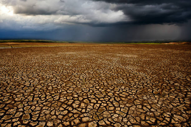 istock thunder storm sky Rain clouds Cracked dry land 1188524554
