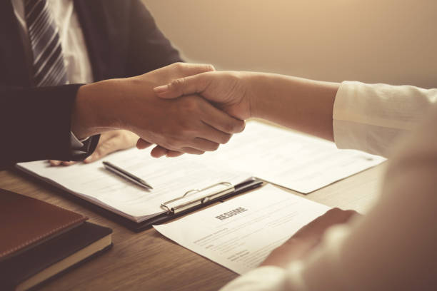 istock Manager and employee interview concept with handshake after talking about contract signing. 1188527499